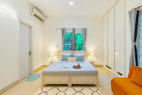 a bedroom with a bed and a window at Alaya Stays 3 BHK Pet friendly with Pvt Pool - Daffodil in New Delhi