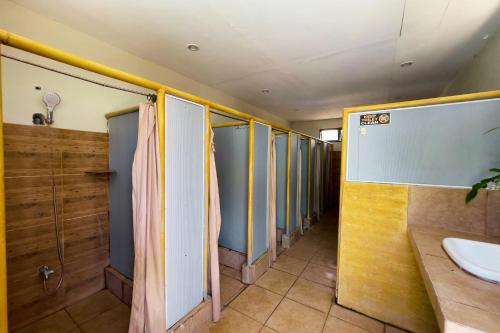 a row of stalls in a bathroom with a sink at Villa Espinoza Beach Resort Nasugbu in Nasugbu