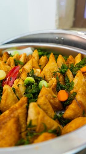 a dish of food with vegetables on a plate at Jiwar Al Madina Hotel in Al Madinah