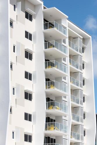 a white apartment building with balconies at Riviera Mackay in Mackay