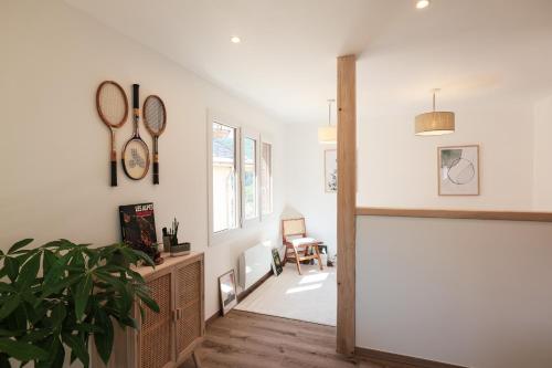 a hallway with white walls and a potted plant at En plein centre du village ! in Villard-de-Lans