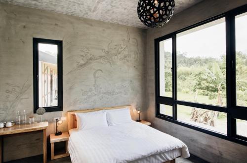 a bedroom with a bed and a large window at 八番私人住宅 Residence8 in Sun Moon Lake