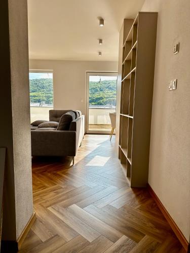 a living room with a couch and a window at SILVER apartment - Rezidencia Bojnice in Bojnice