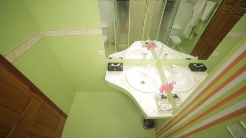 a bathroom with two sinks and a mirror at Four Squares by WI Hotel in Karachi