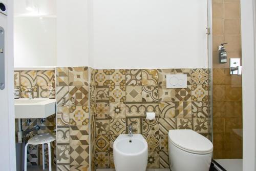 a bathroom with a toilet and a sink at SMART Rooms Pistoia in Pistoia