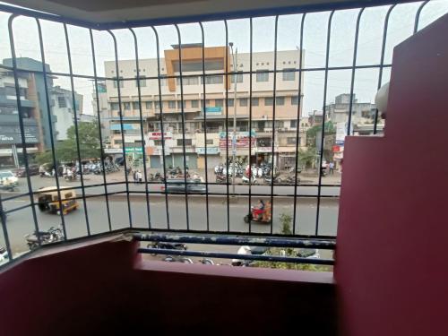 a view of a city street from a balcony at Hotel Parth Residency in Kolhapur