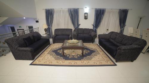 a living room with couches and a coffee table at Four Squares by WI Hotel in Karachi