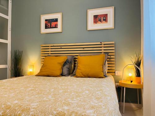 a bedroom with a large bed with yellow pillows at The Green Terrace in Bajamar