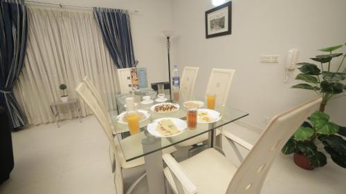 a table with plates of food on it in a room at Four Squares by WI Hotel in Karachi