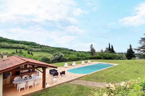a swimming pool with chairs and a pavilion at Saint-Fortunat - Authentic Home with Pool - Saint-Didier-au-Mont-d'Or in Saint-Didier-au-Mont-dʼOr