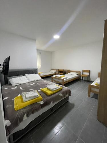 a bedroom with a large bed with yellow towels on it at Vile Jana in Leskovac