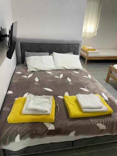 a bed with two towels on top of it at Vile Jana in Leskovac
