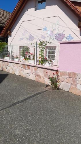 a building with a painting on the side of it at Olympe in Dessenheim