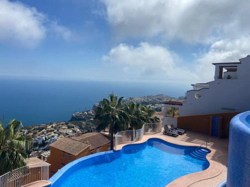 a villa with a swimming pool and a view of the ocean at Casa Boho in Cumbre del Sol