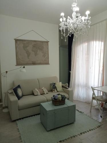 a living room with a couch and a chandelier at La casa di Lilia in Francavilla al Mare