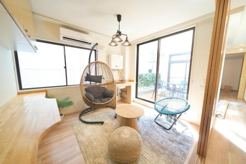 a living room with a chair and a table at FINOA Penthouse Suite Ikebukuro Sunshine in Tokyo