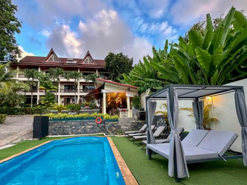 a villa with a swimming pool and a resort at Sea Hills Resort in Patong Beach
