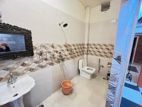 a bathroom with a sink and a toilet at Karma homestay in Jodhpur
