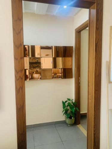a hallway with a room with a potted plant at Panorama Apartment Zone Touristique Haut Standing in Mahdia