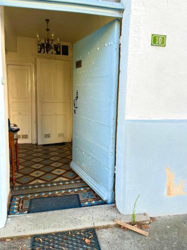 an entrance to a building with a blue door at Grand family home in the heart of Burgundy! in Saint-Berain-sur-Dheune