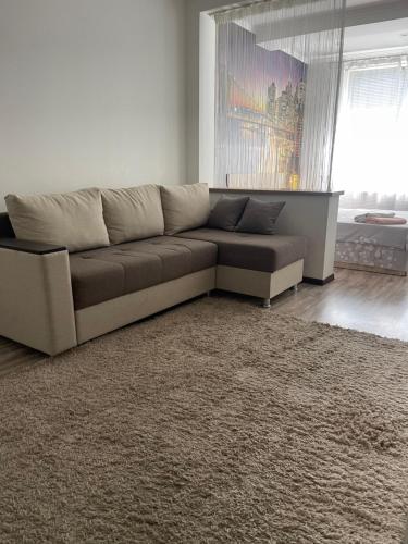 a living room with a couch and a rug at Уютная квартира in Chişinău
