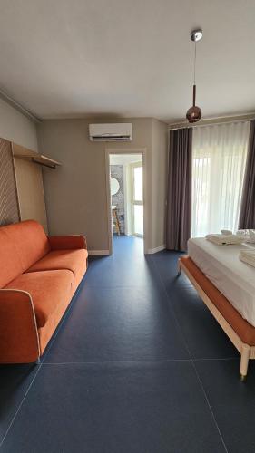 a hotel room with a bed and a couch at EKOA comfort e relax in San Nicola Arcella