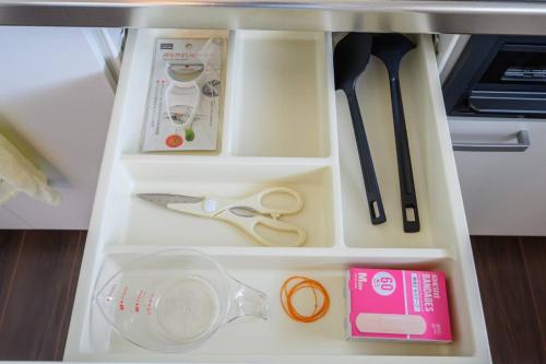 a drawer with some kitchen utensils in it at Kizuna House Yuzuriha in Minamiawaji