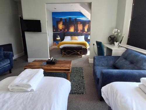 a living room with a couch and a bed at No 27 Chapel Street Guest House in Llandudno