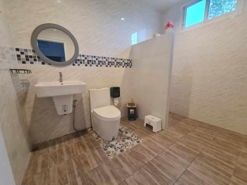 a bathroom with a sink and a toilet and a mirror at Huahin Friends Pool Villa 1 in Hua Hin