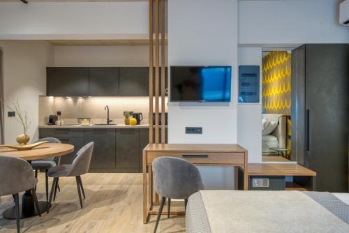 a kitchen and dining room with a table and chairs at Amphora Nafplio- elegance Suites Apartmenthouse in Nafplio