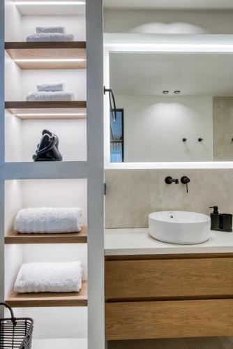 a bathroom with a sink and a mirror at Amphora Nafplio- elegance Suites Apartmenthouse in Nafplio