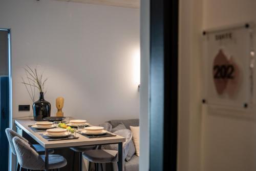 a table with dishes on it in a living room at Amphora Nafplio- elegance Suites Apartmenthouse in Nafplio