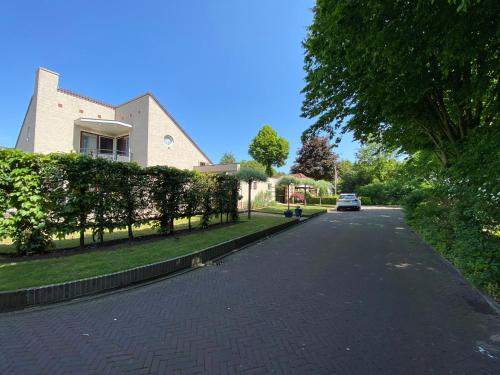a house with a car parked on a driveway at La Nuova Casa del Campo (vh De Kamp) in Dinxperlo