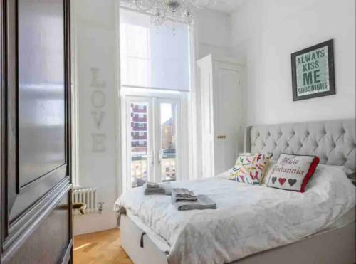 a bedroom with a large bed and a window at Breathtaking Walpole Sea Views in Margate
