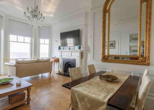 a living room with a table and a mirror at Breathtaking Walpole Sea Views in Margate