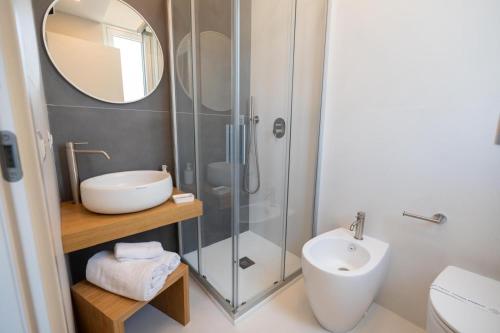 a bathroom with a shower and a sink and a mirror at La Piazzetta Room in Palma di Montechiaro
