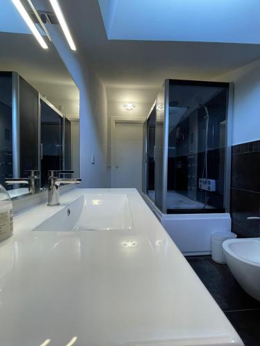 a bathroom with a large white tub and a sink at Casa di Jo in Empoli