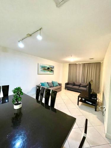 a living room with a table and a couch at Private bedroom in Miami - Coral Gables 601 in Miami