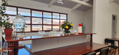 a dining room with a table and a large window at Solara Art Hotel by Amak in Cusco