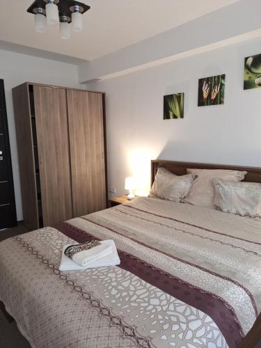 a bedroom with a bed with a towel on it at Promenade apartment in Târgu-Mureş