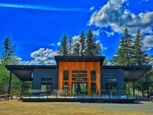 a modern house with a blue roof at LuxQuarters Huckleberry Suite in Kitimat