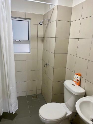 a bathroom with a toilet and a sink at Tiny Sweet Home in Kajang