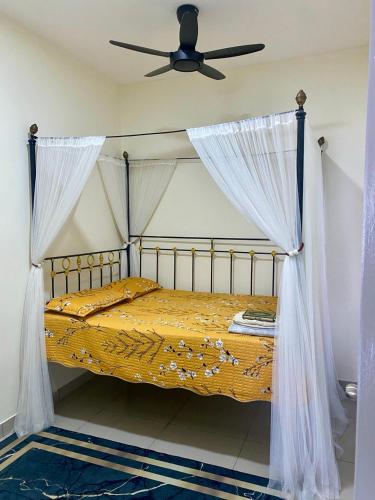 a bedroom with a bed with a ceiling fan at Tiny Sweet Home in Kajang