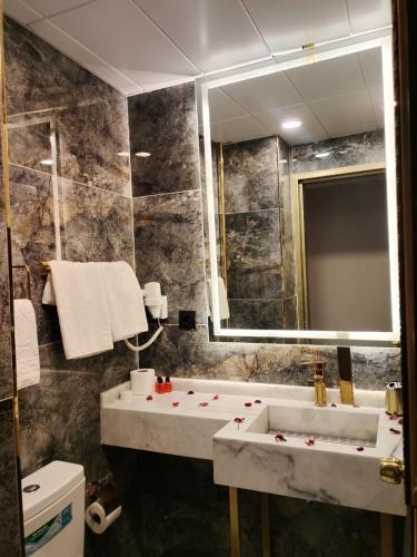 a bathroom with a sink and a mirror at Green Anka Hotel in Istanbul
