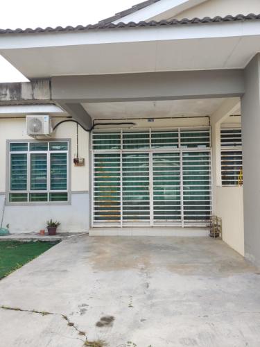 a garage with closed blinds on a house at Homestay NAQ D' Kuala Kangsar in Kuala Kangsar