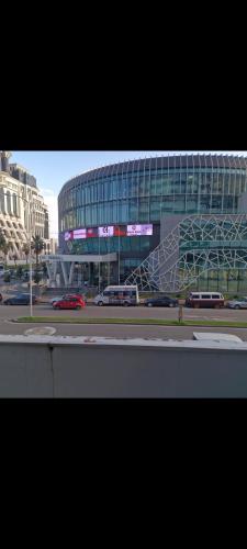 a large glass building with a building with a metal staircase at Orbi residence in Angisa