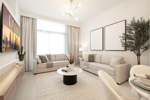 a living room with white furniture and a large window at Burj Crown - Urban Chic Opera Boulevard View, Walk to Dubai Mall in Dubai