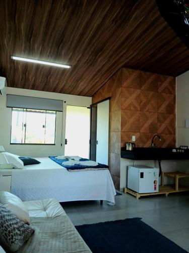 a large bedroom with two beds and a fireplace at Pousada Bela Vista in Sengés