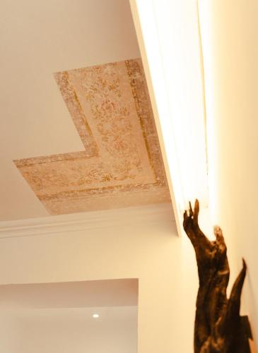 a ceiling with a painting of a letter k on it at Hotel Villa Freiheim in Merano