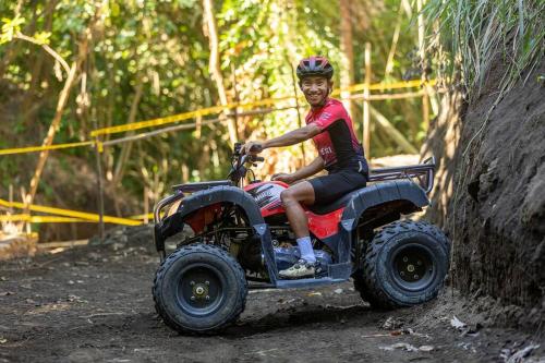 a man riding on a four wheeler on a dirt road at Zen Pod by Jen in Lemery